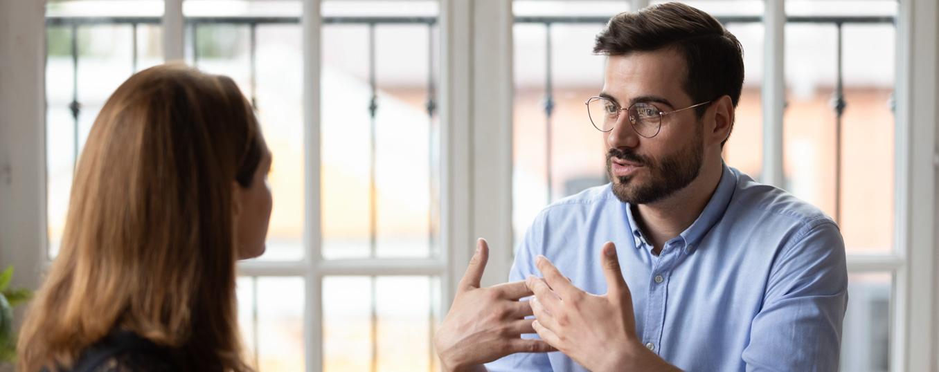 man speaking to woman