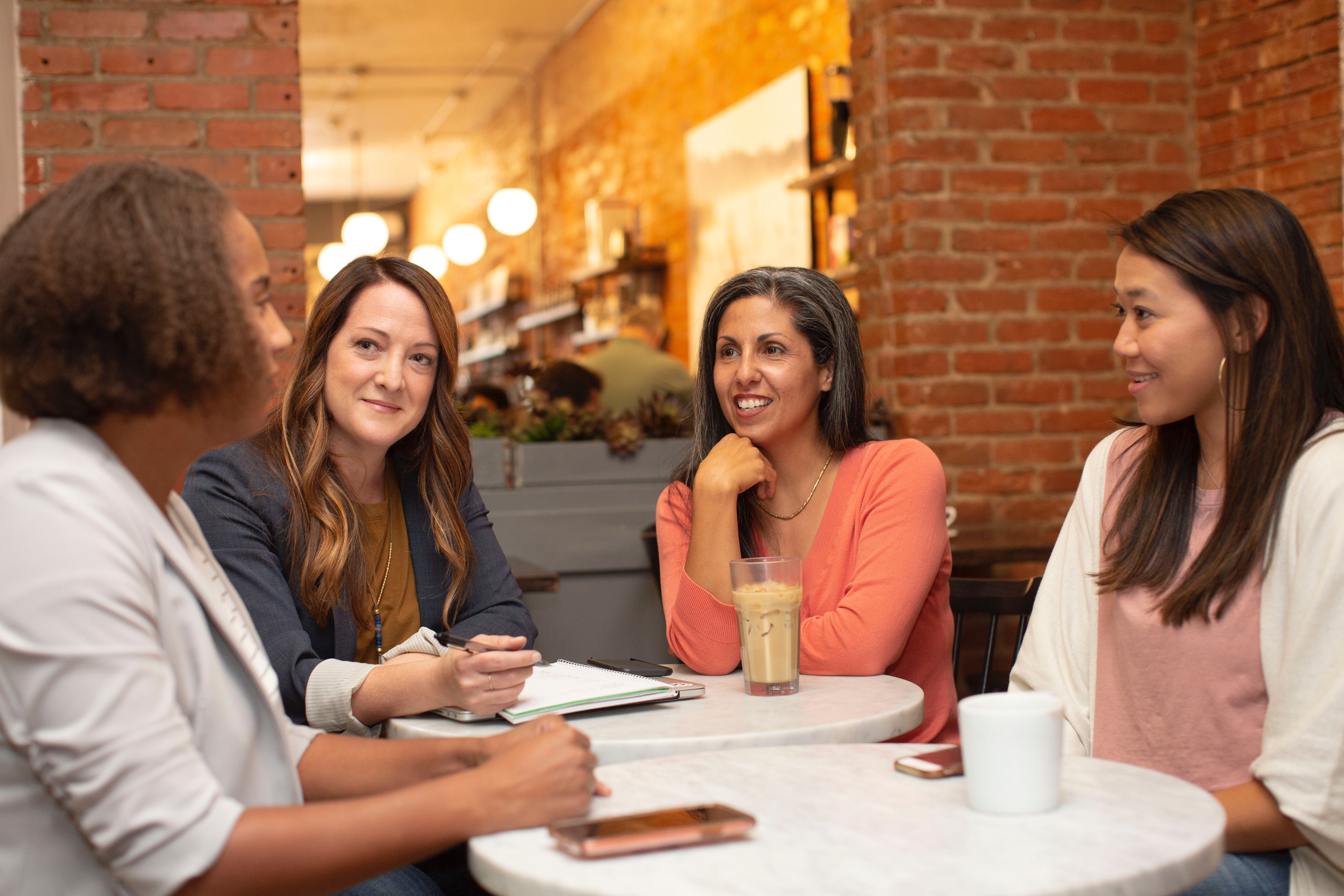 A group of women meet over coffee