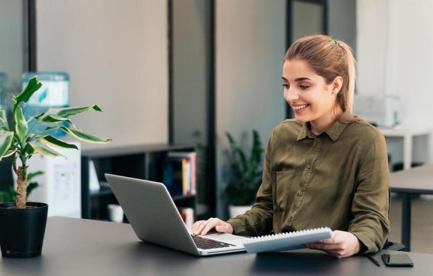 woman smiling at laptop screen