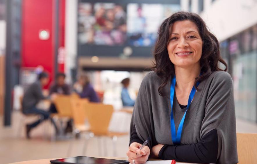 woman smiling at the camera from her desk