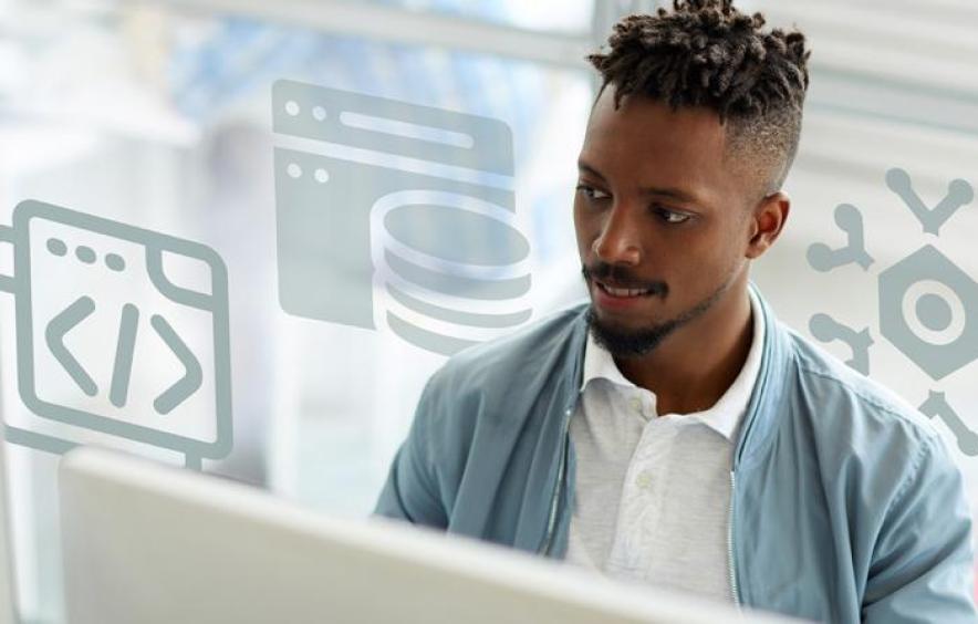 Person working on a computer with software development icons