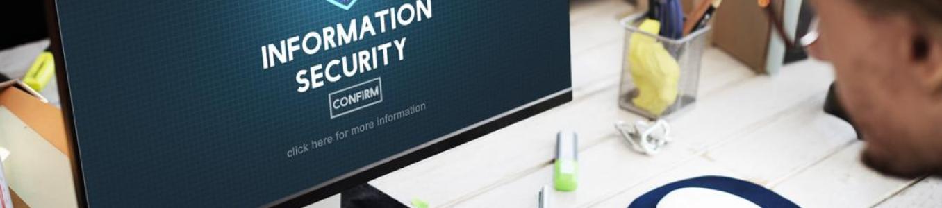 Person working at a computer displaying an “Information Security” screen