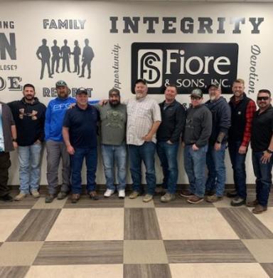 group of employees standing in a row at coaching skills training